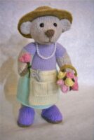 knitted toy of a lady bear dressed as a flower arranger