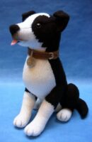 A knitted toy of a black and white border collie