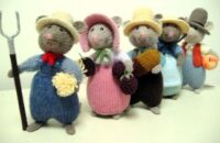 knitted toys of mice in homely farm costumes