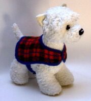 knitted toy of a West Highland Terrier in a tartan coat