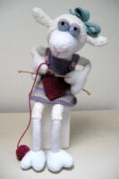 knitted toy of a sheep knitting a heart