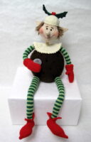 knitted toy of a piskie dressed as a plum pudding