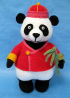 knitted toy of a panda in Chinese style clothes