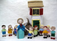 knitted toys of the old woman who lived in a shoe with her shoe house and children