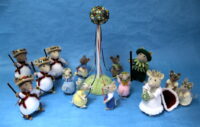 a band of mice knitted toys around a maypole