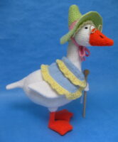 knitted toy of a goose in a bonnet and shawl