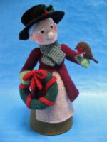 knitted toy of a Dickensian lady with a Christmas wreath