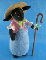 knitted toy of a sheep dressed as a pastoral shepherdess