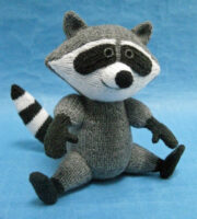 knitted toy of a smiling raccoon