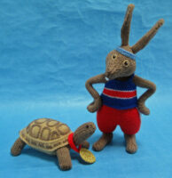 knitted toys of a tortoise and a hare in running clothes