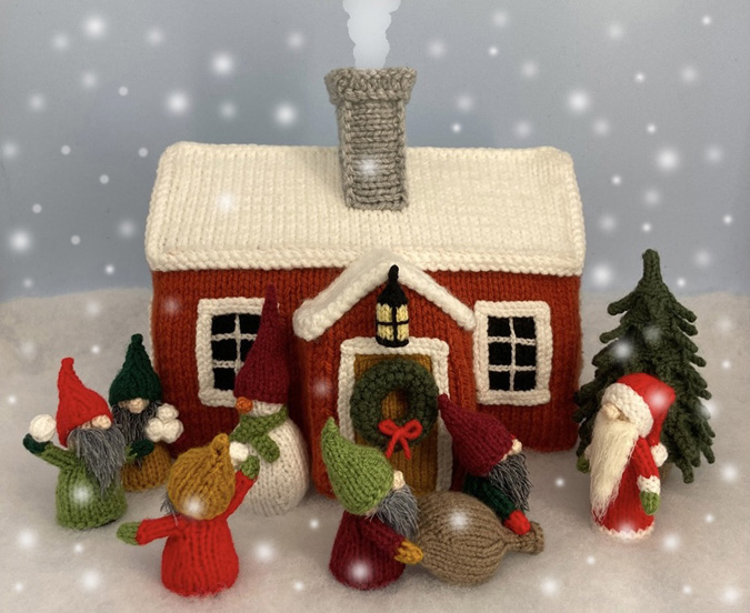 Knitted toy of Santa's cabin with his helpers