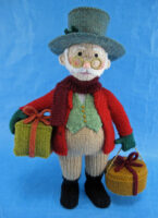 knitted toy of a Dickensian man carrying parcels