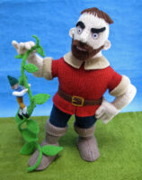 knitted toys of the Giant holding up a beanstalk with Jack climbing up it