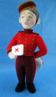 knitted toy of a kissogram boy dressed as a bellhop