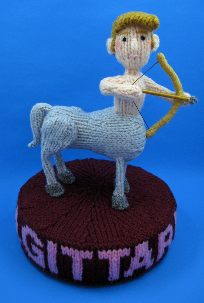 knitted toy of a centaur with a bow