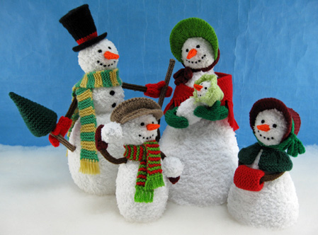 knitted toys of a family group of snow characters