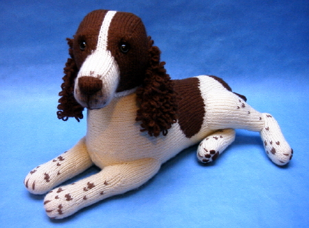 knitted toy of a brown and white Springer Spaniel