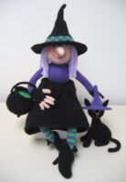 knitted toys of a witch and her cat